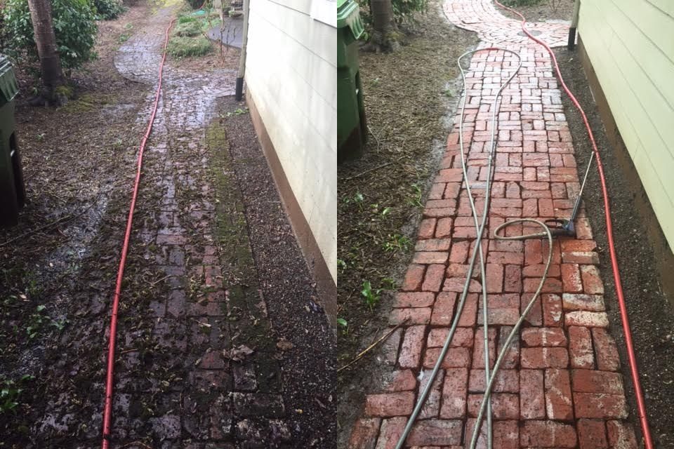 Side-by-side before and after of a brick paver walkway — mossy, debris-covered pavers on the left, clean red brick on the right