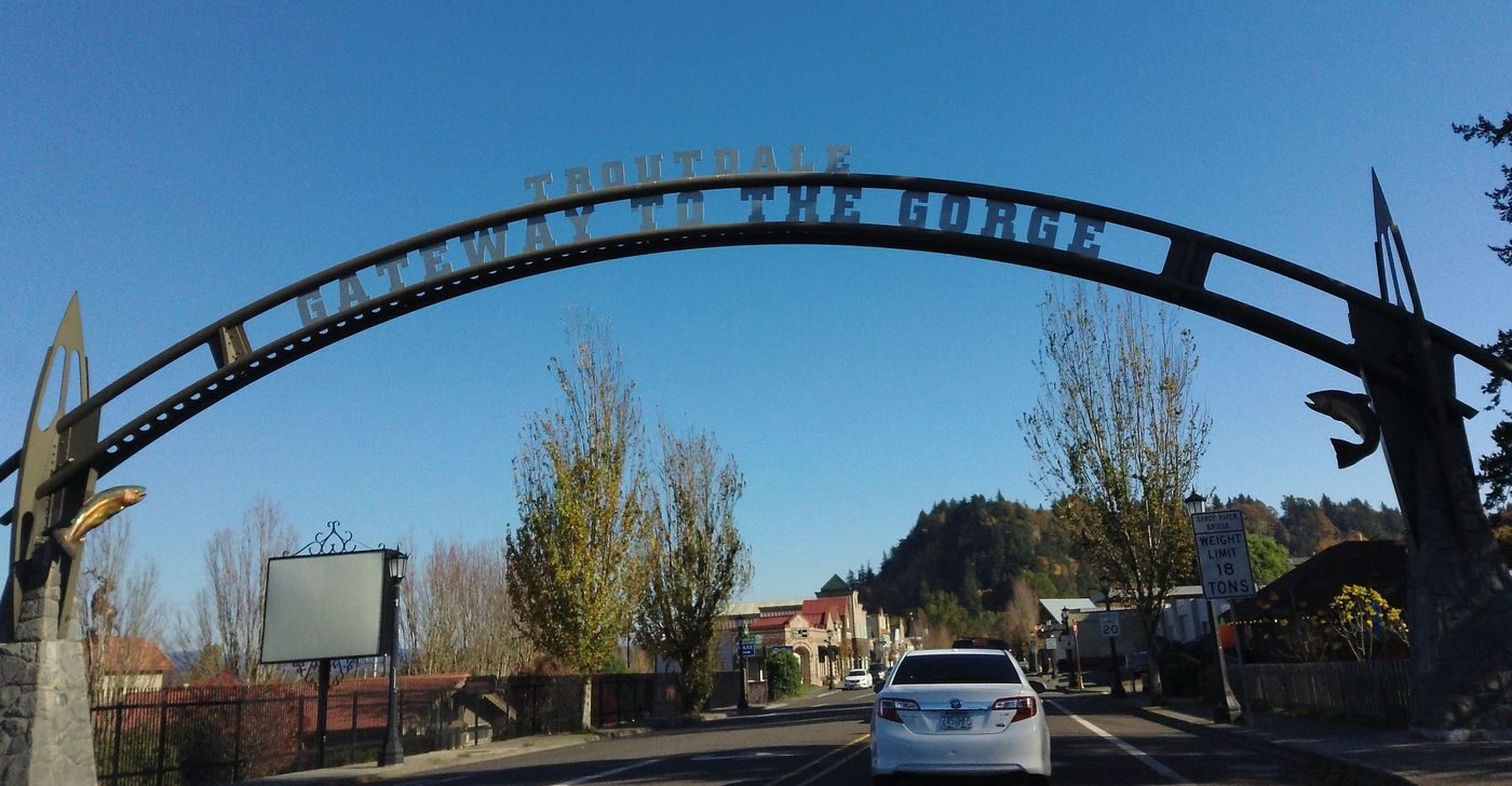 The Troutdale Centennial Arch spanning the Historic Columbia River Highway — the city's namesake gateway landmark at the mouth of the Columbia River Gorge