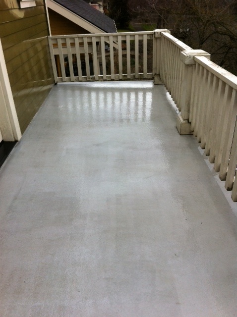 Same concrete deck landing and stairway after pressure washing, clean and bright
