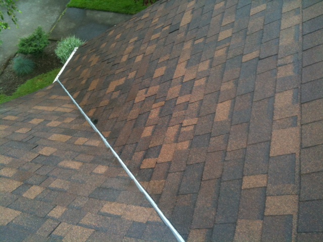 Same roof valley after cleaning, moss removed and shingles clear